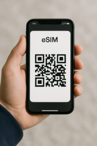 Person holding an iPhone with an eSIM QR Code